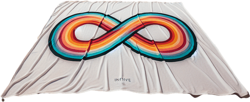 full view of a Beach white towel with colored infinte logo. placed on the sand.
photo